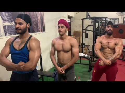 shredded bodybuilder muscle posing and my student muscle posing gym