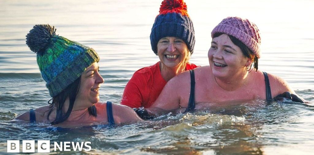 Getty Images Family having a moment together messing about while winter sea swimming