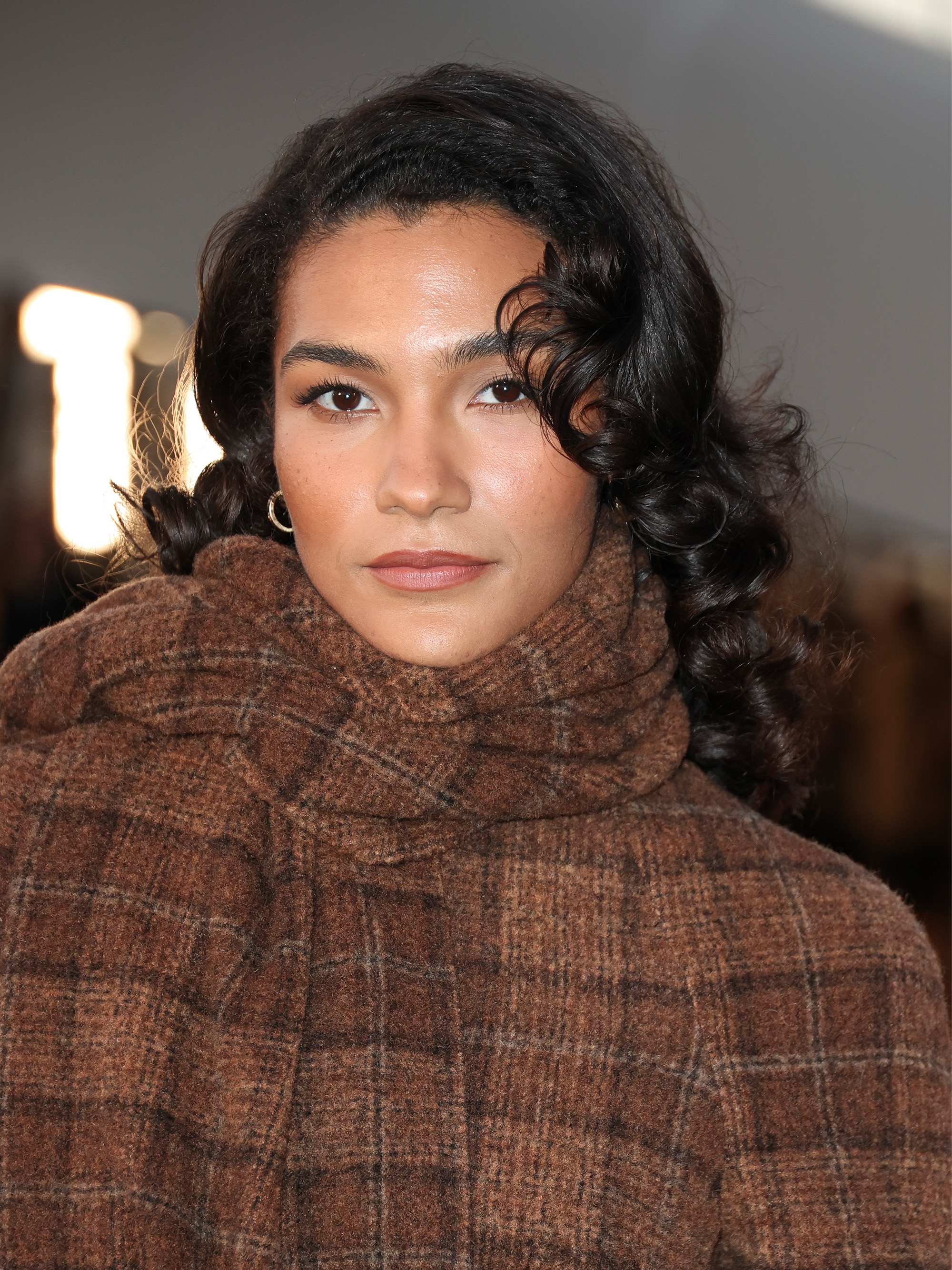 Olivia Dean attends the Burberry spring/summer 2026 show during London Fashion Week, September 2025 with warm-toned makeup