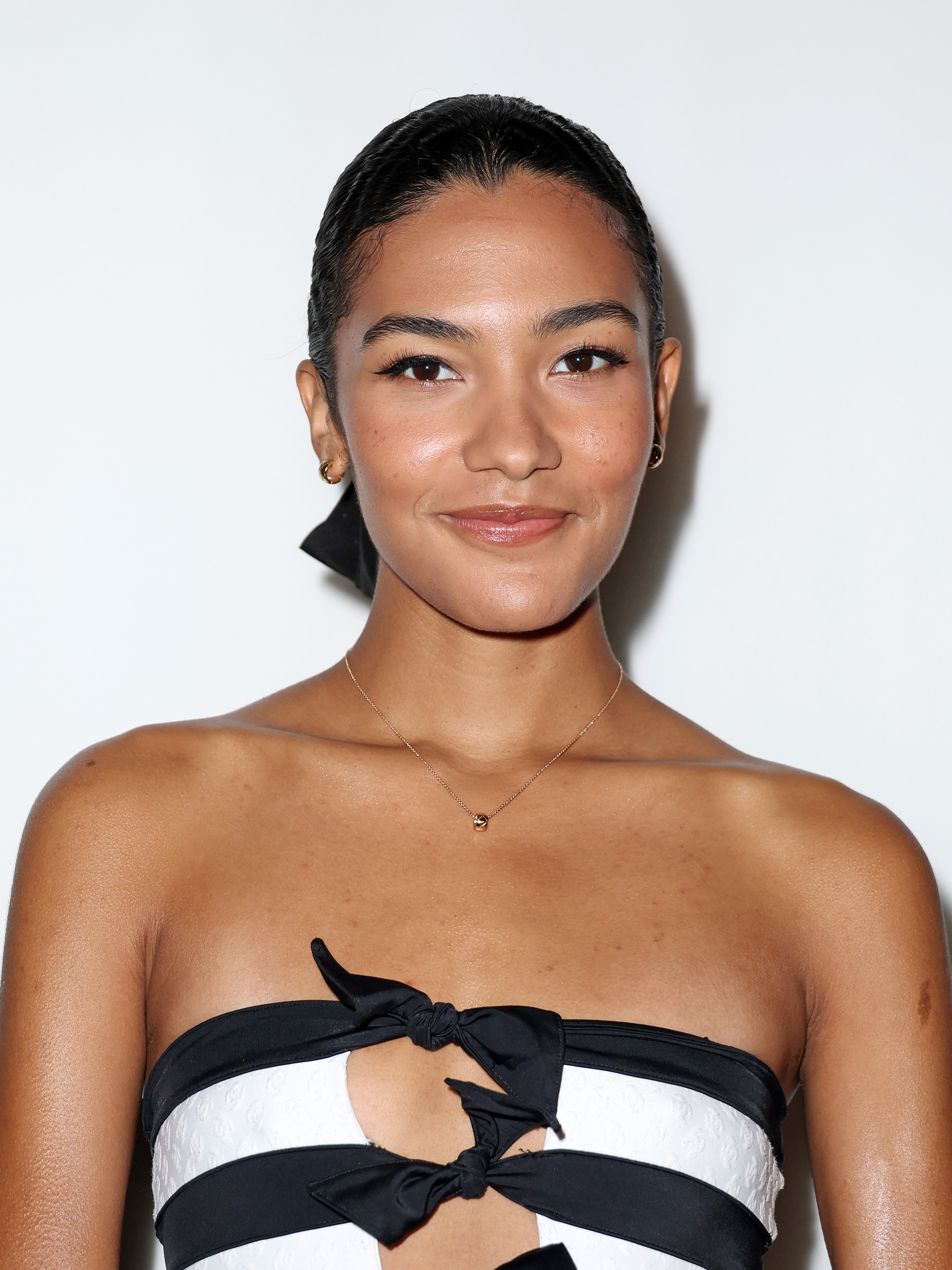 Olivia Dean attends the Chanel Womenswear fall/winter 2024-2025 during Paris Fashion Week with a glowy, bronzed complexion