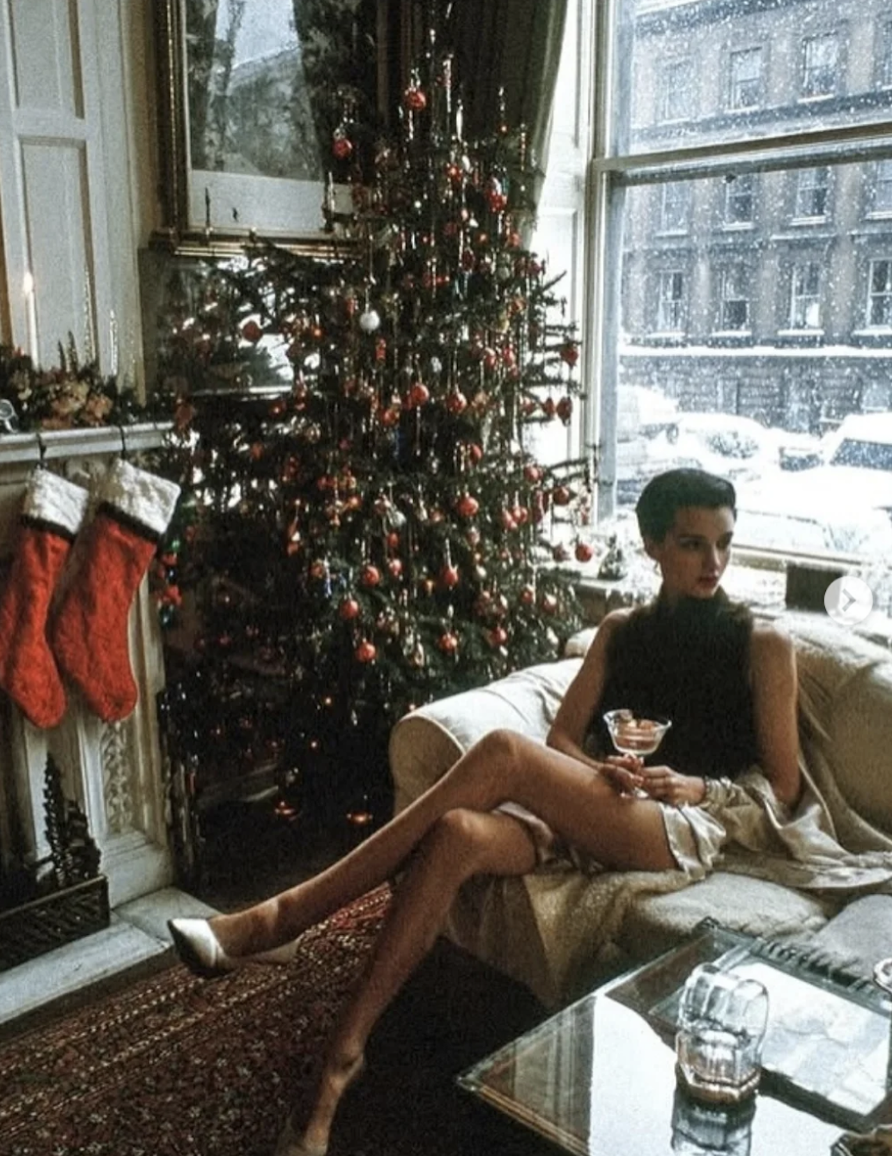 Women drinking martini in Christmas decorated home