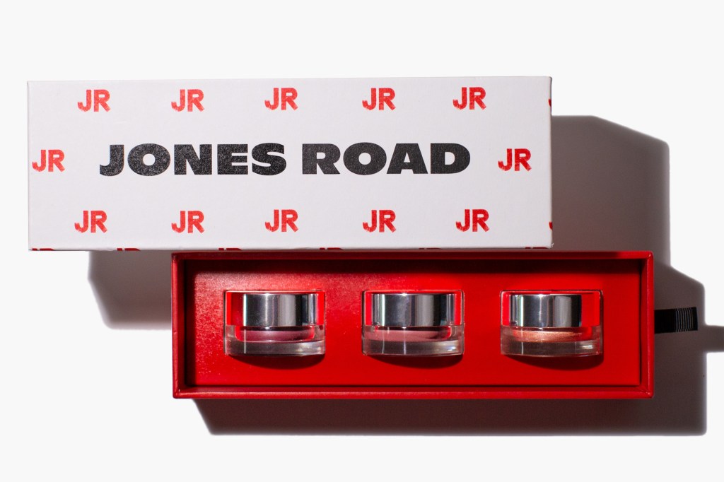 Jones Road makeup kit with three small pots of product inside a red box, with a white lid featuring the "JONES ROAD" logo.