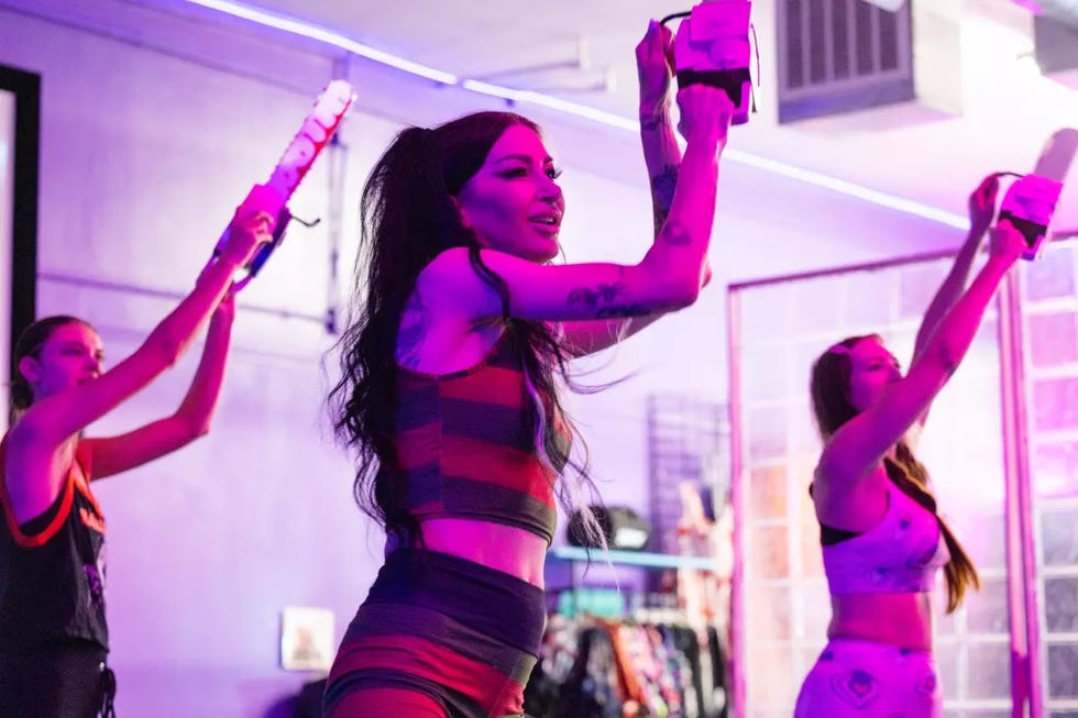 group fitness class with participants using light weights