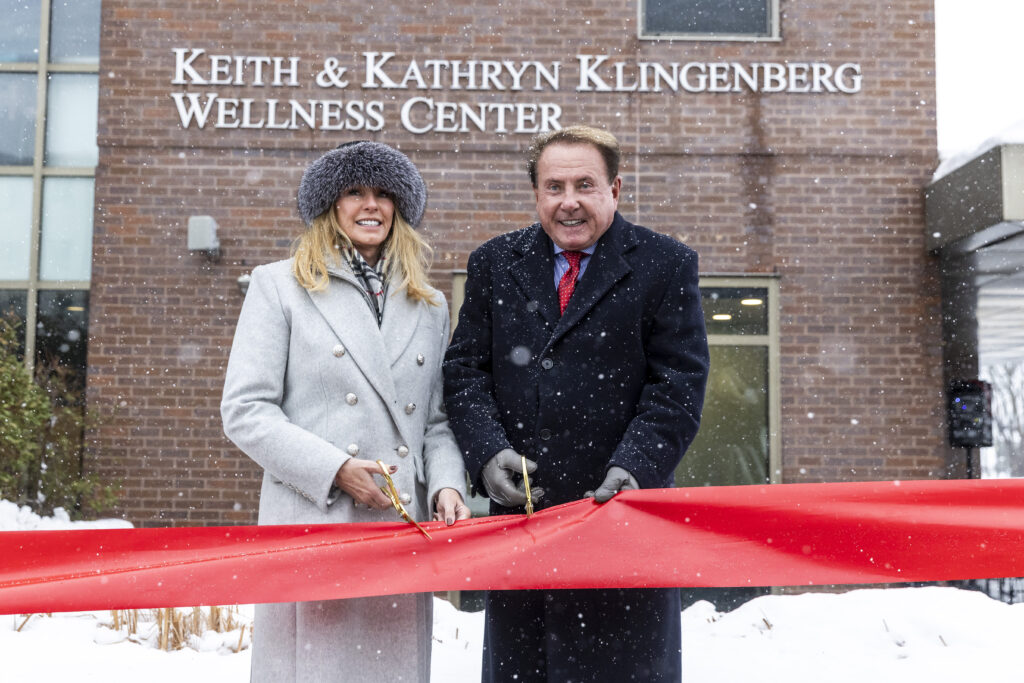 Kathryn, left, and Keith Klingenberg cut a ribbon at a dedication ceremony held outside the newly named Keith and Kathryn Klingenberg Wellness Center at Davenport University in Grand Rapids, Mich. on Wednesday, December 10, 2025.
