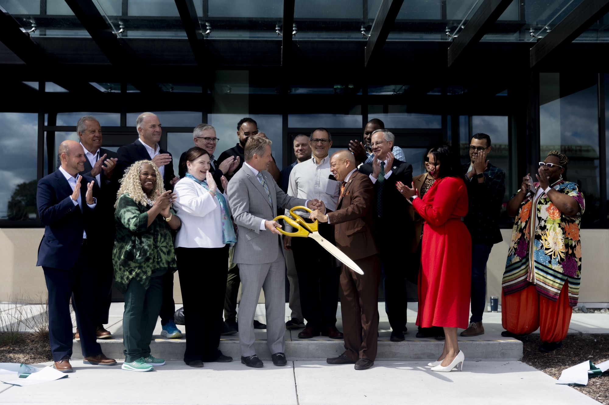 Flint Mayor Sheldon Neeley and Kevin M. Guskiewicz, president of Michigan State University, cut the ribbon together with other officials at the ribbon cutting ceremony of Michigan State University College of Human Medicine’s second building in downtown Flint. (Jake May | MLive.com)