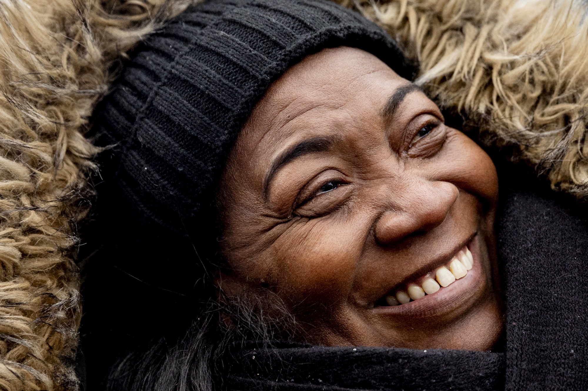 Portia Titus, 63 of Detroit, smiles as she watches floats go by in America’s Thanksgiving Parade presented by Gardner White on Thursday, Nov. 27, 2025 along Woodward Avenue in downtown Detroit. (Jake May | MLive.com)