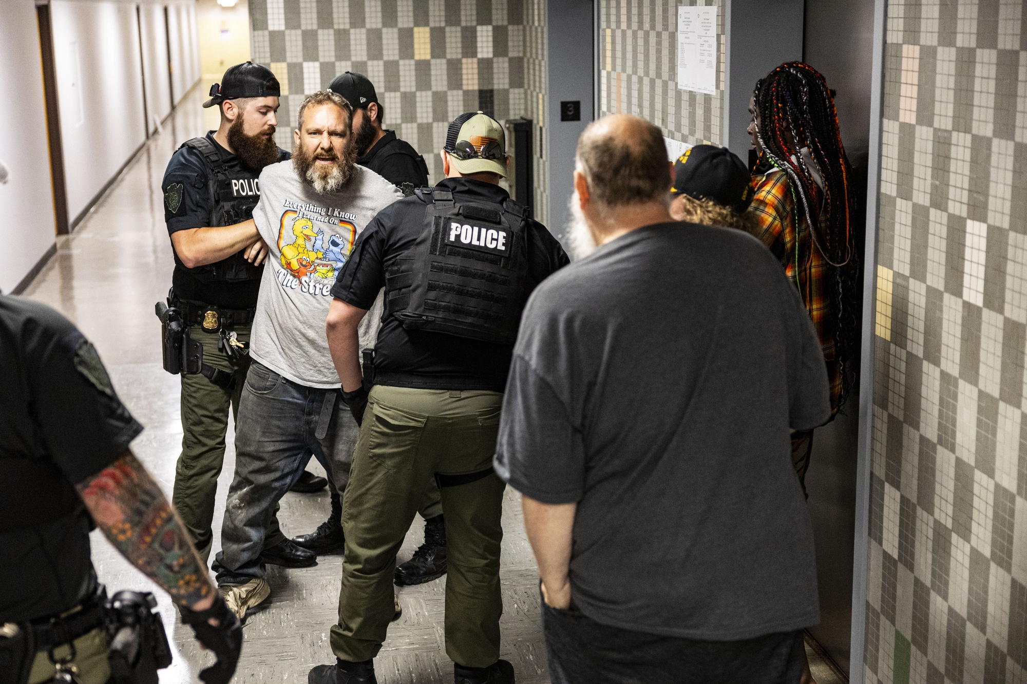 Flint police officers arrest a community member after being removed from a Flint City Council finance committee meeting on Wednesday, June 18, 2025, at Flint City Hall in Flint.