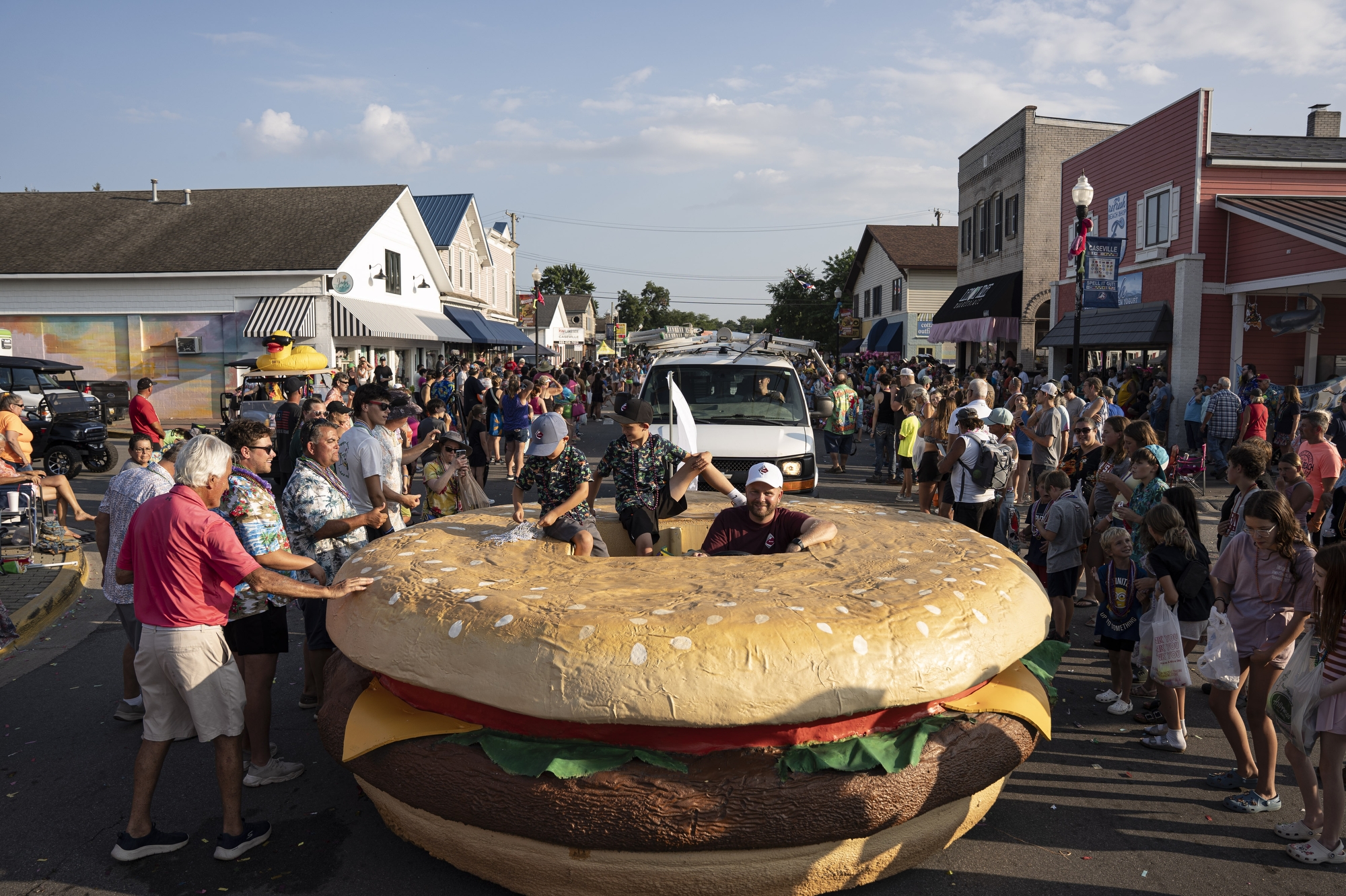 A large mobile cheeseburger makes its way down the street during the ‘parade of fools’ at the Cheeseburger Festival in Caseville on Wednesday, August 13, 2025.