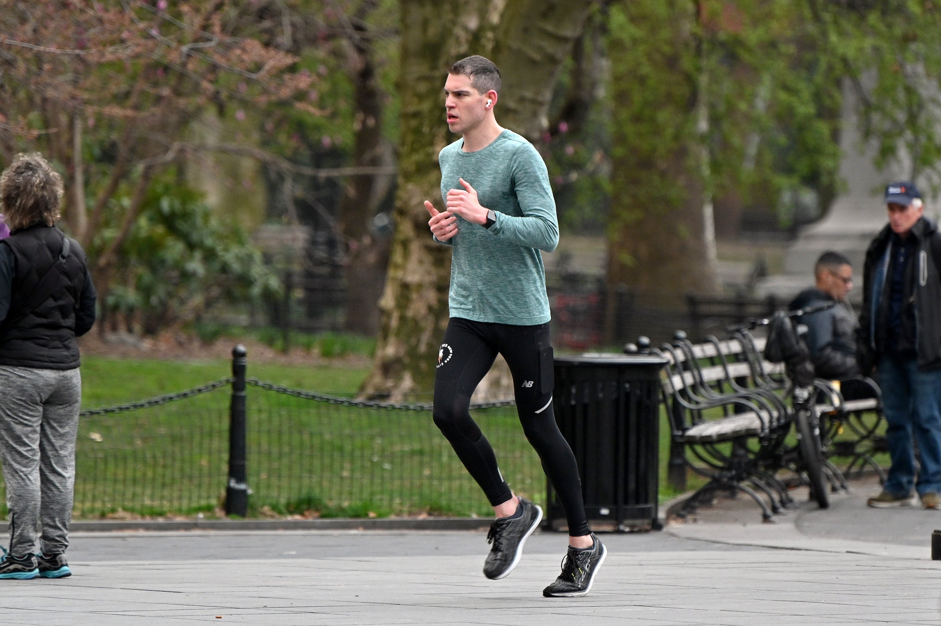 A man runs in New York City’s Washington Square Park in March 2020. People training for races can reduce their risk of injury by incorporating cycling and other cross-training exercises into their workouts