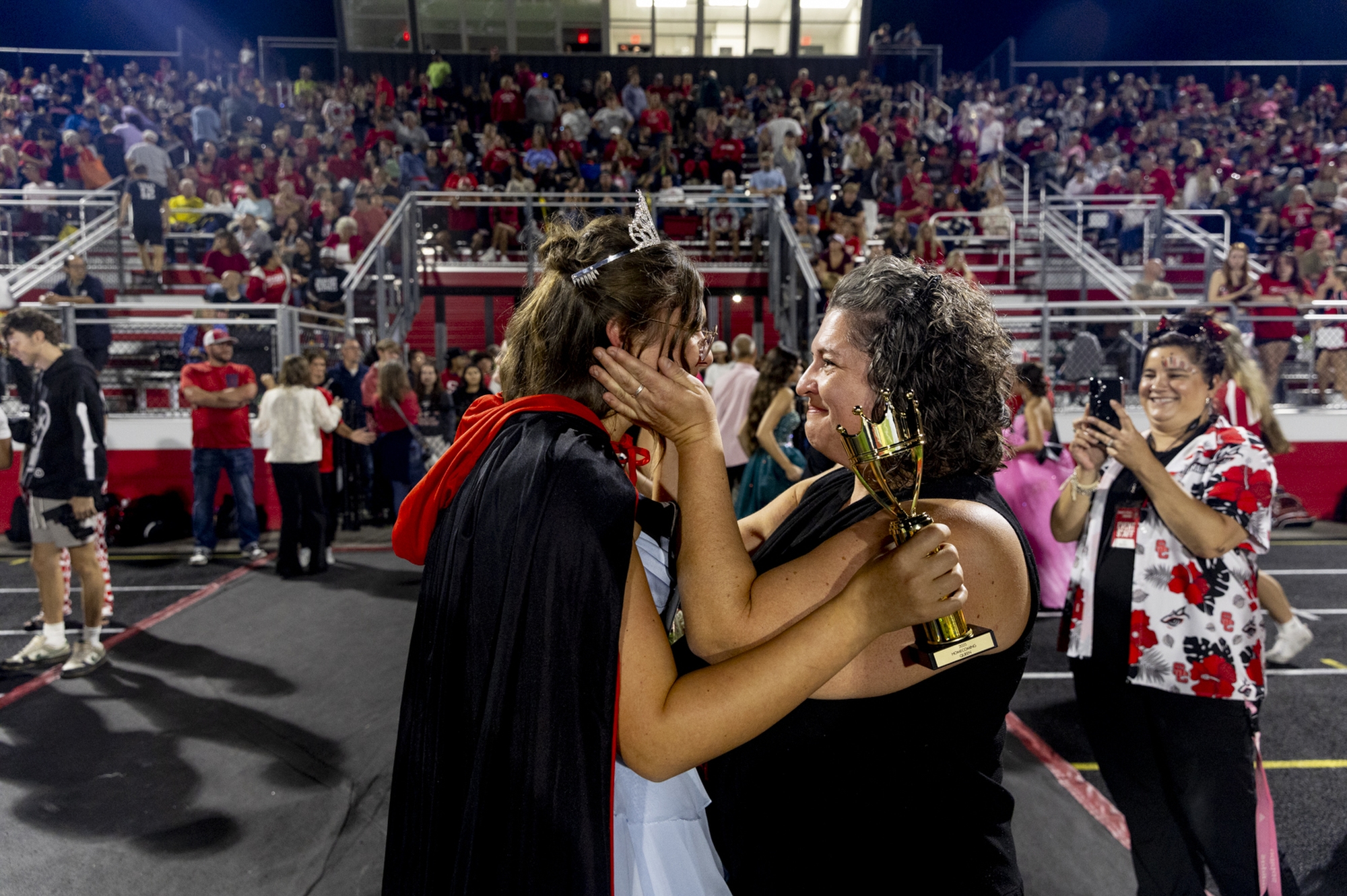 Jennifer Hein, mother at right, smiles as she takes in the moment with her daughter, Swartz Creek senior Miriam Hein, after she was crowned homecoming queen on Friday, Sept. 26, 2025 at Swartz Creek High School. “It means so much. I’m so excited and so blessed, and I am so thankful to all of my classmates that voted for me. This is just a special moment,” Miriam Hein said. “This school and community, it really shaped me into who I want to be. … I love it and I love the people here. I’ve made some amazing friends, and bonds that will last forever.”