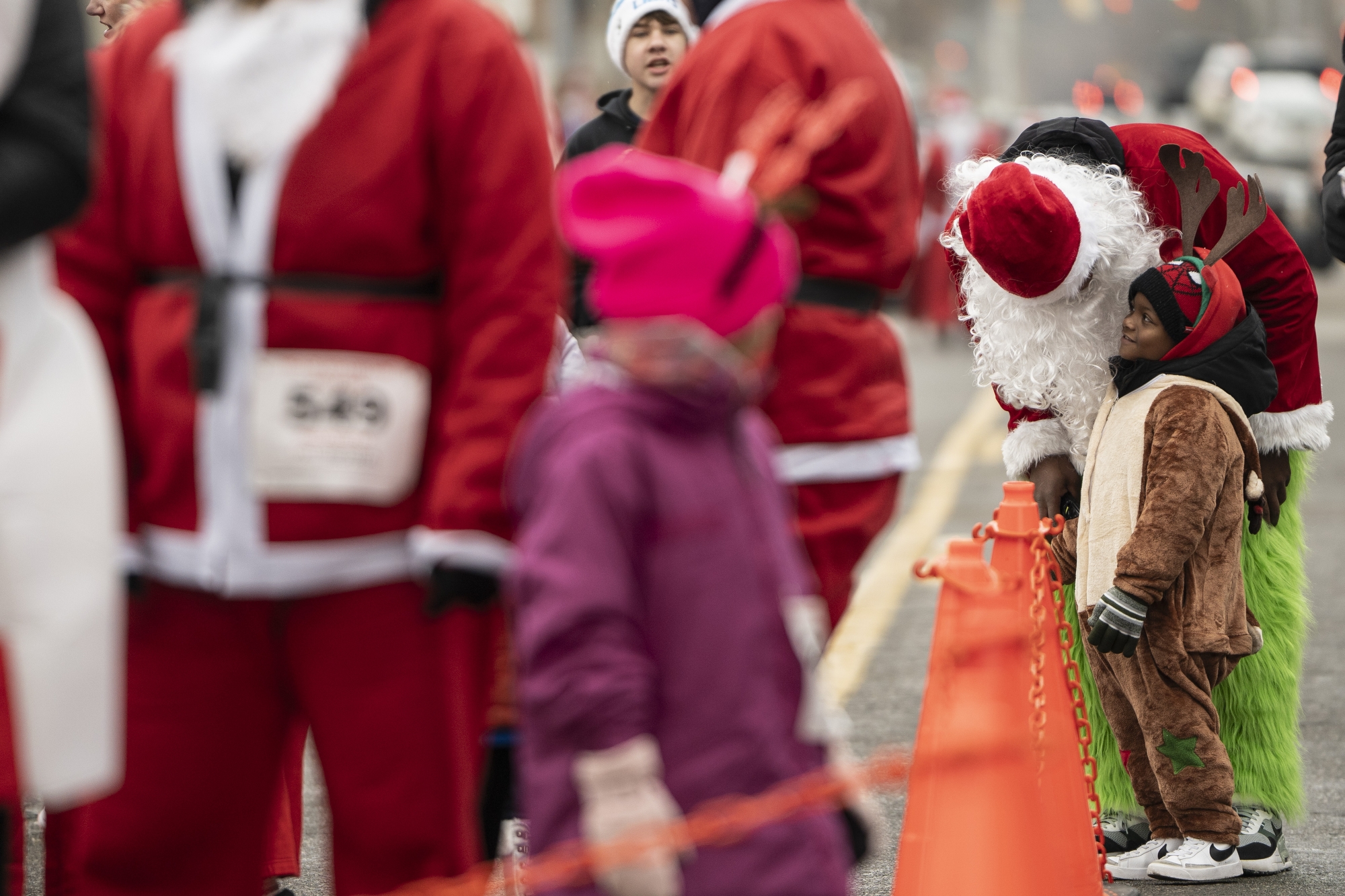 Children and parents line up for the Reindeer Run during the 16th annual YMCA Santa Run in downtown Flint on Saturday, Dec. 6, 2025.