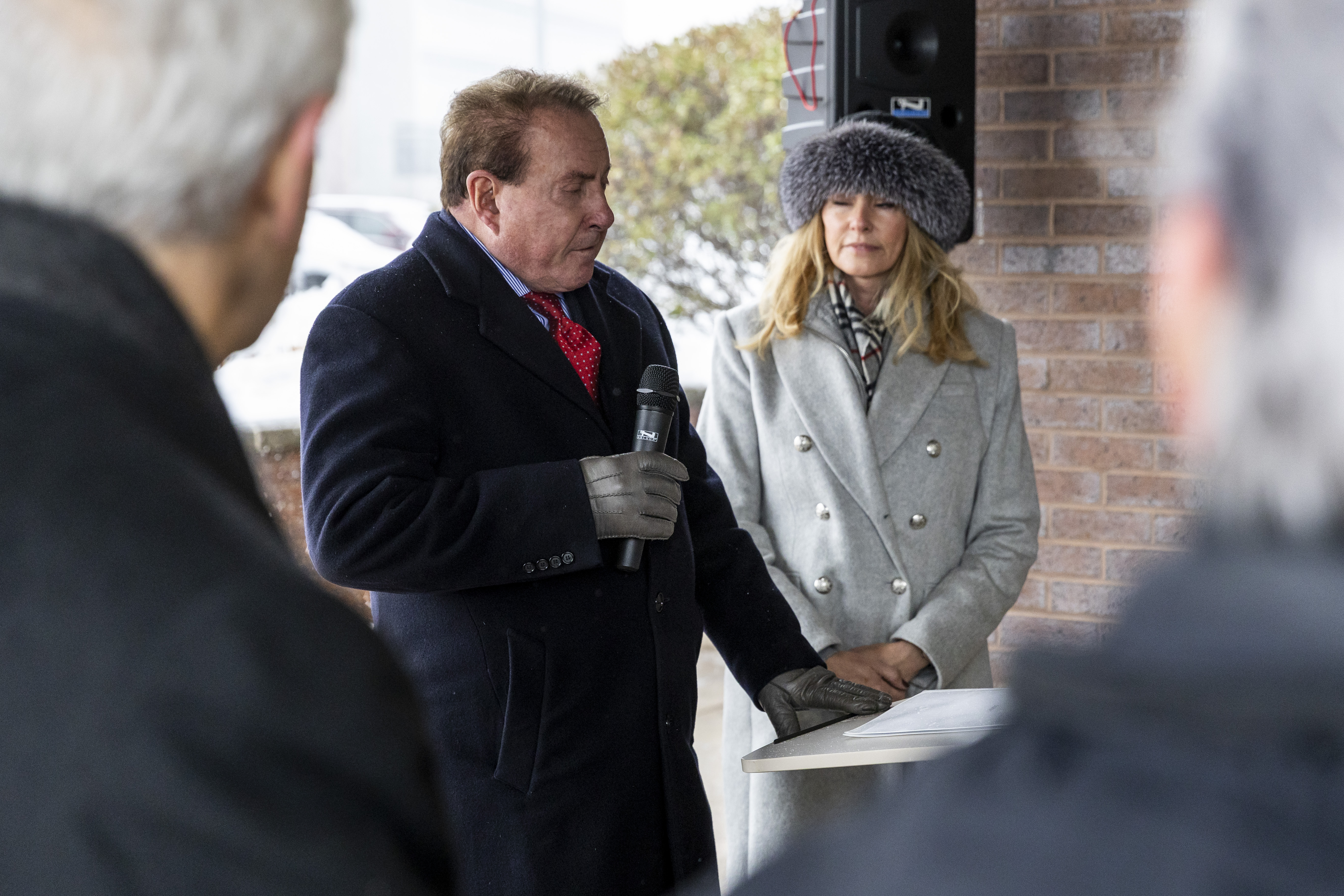 Keith, left, and Kathryn Klingenberg are honored at a dedication ceremony held outside the newly named Keith and Kathryn Klingenberg Wellness Center at Davenport University in Grand Rapids, Mich. on Wednesday, December 10, 2025.