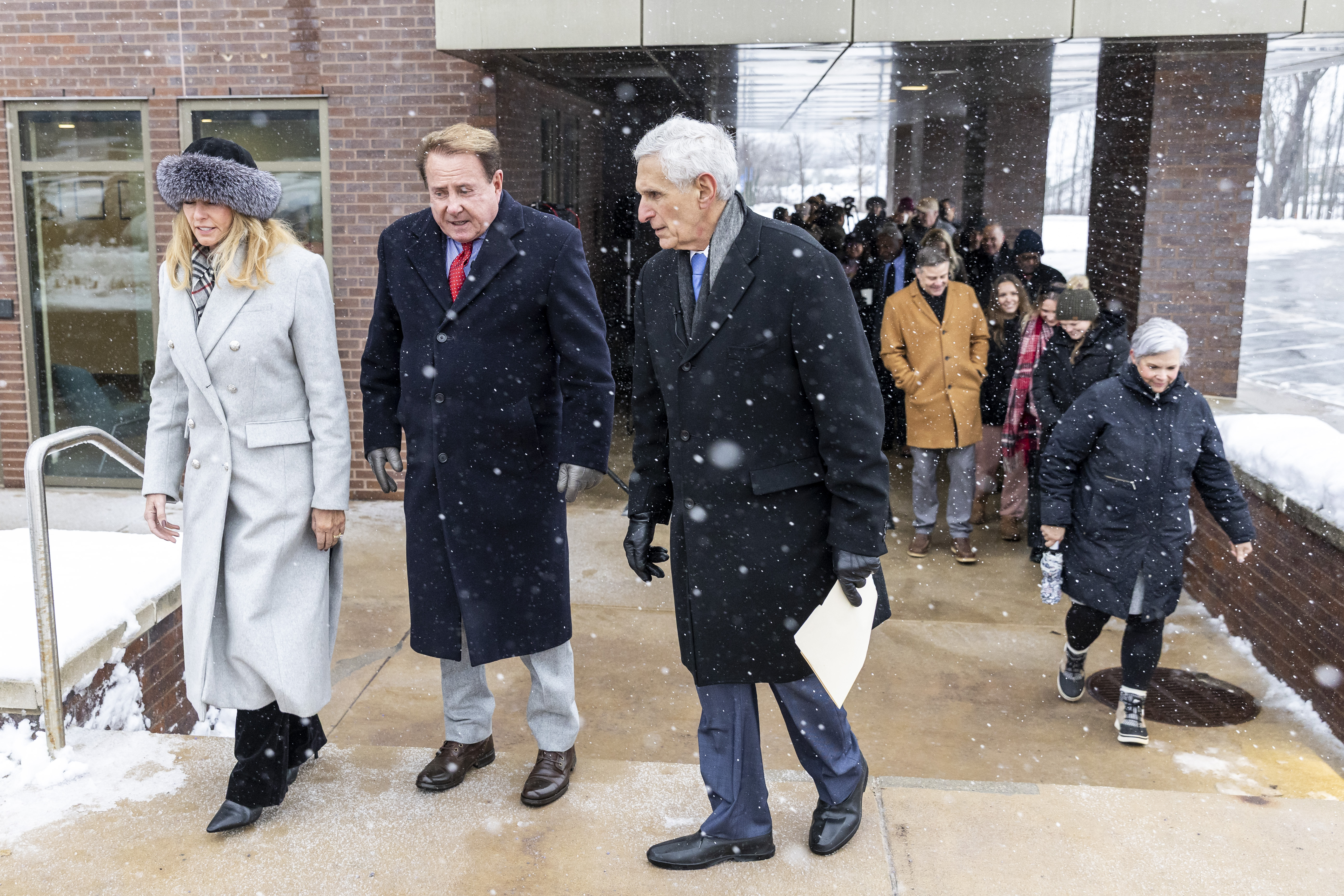 Kathryn, left, and Keith Klingenberg are joined by university president Richard J. Pappas for a ribbon cutting at a dedication ceremony held outside the newly named Keith and Kathryn Klingenberg Wellness Center at Davenport University in Grand Rapids, Mich. on Wednesday, December 10, 2025.