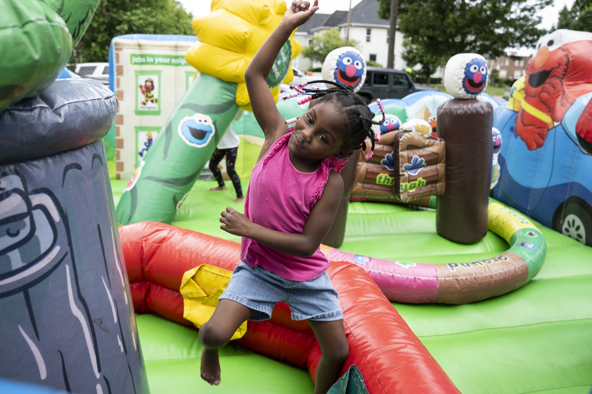 Dangel Taylor, 4, jumps into the air while making a silly face at Harmony Fest IV in Memorial Park in Flint on Thursday, July 17, 2025. 