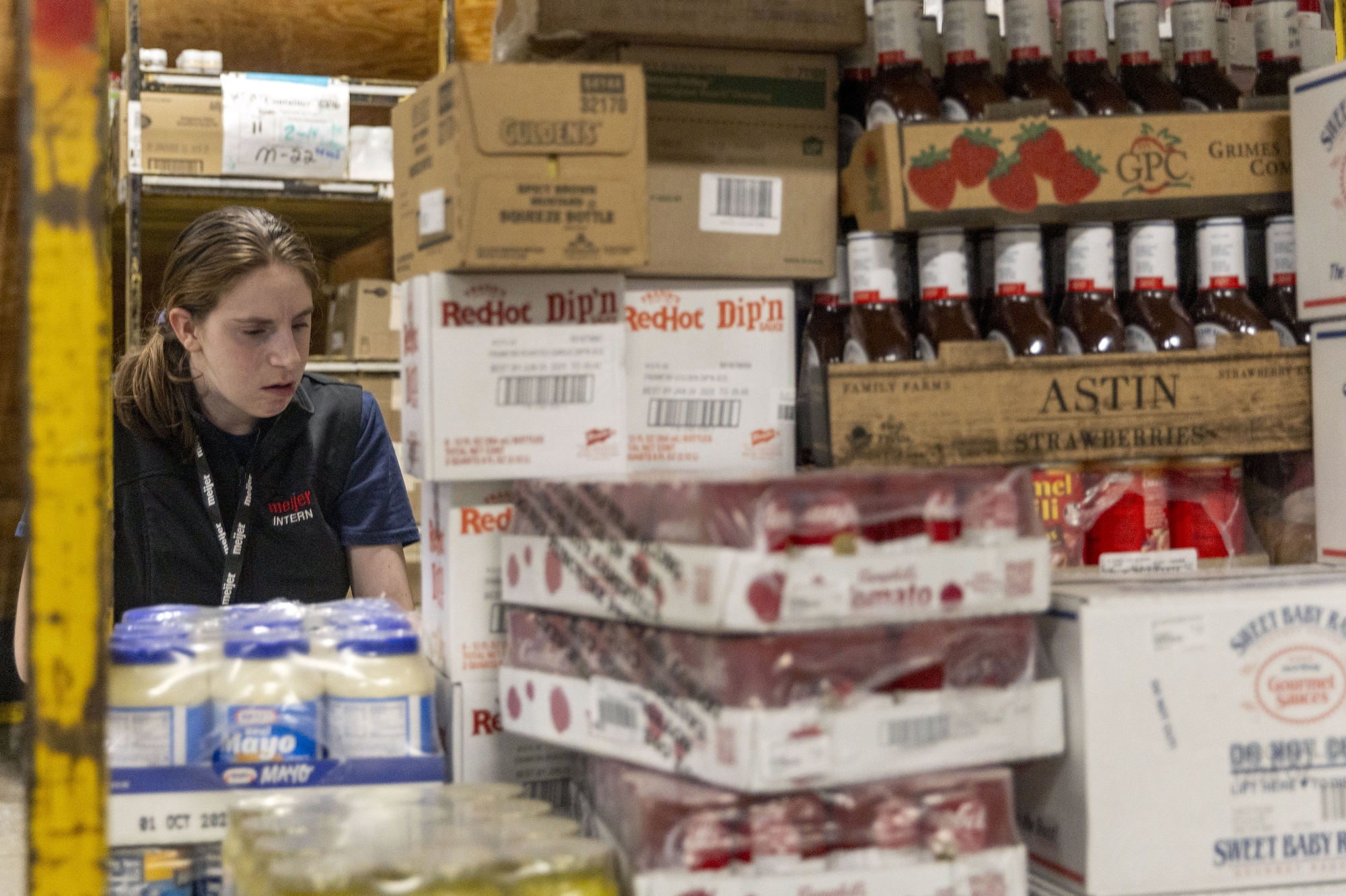 Brooklyn Mulaly, a 20-year-old Flint student who is hearing-impaired, locates and restocks items on Thursday, April 17, 2025 at the Meijer on Center Road in Burton. These interns at the store, located at 2333 S. Center Road, are part of a groundbreaking new partnership between Meijer and Kearsley Community Schools, designed to help special needs students transition into the workforce. The program, called Project SEARCH, launched in September 2024 and is coordinated through the Genesee Intermediate School District. It offers young adults with intellectual and developmental disabilities hands-on job training in a real-world environment. Jake May | MLive.com