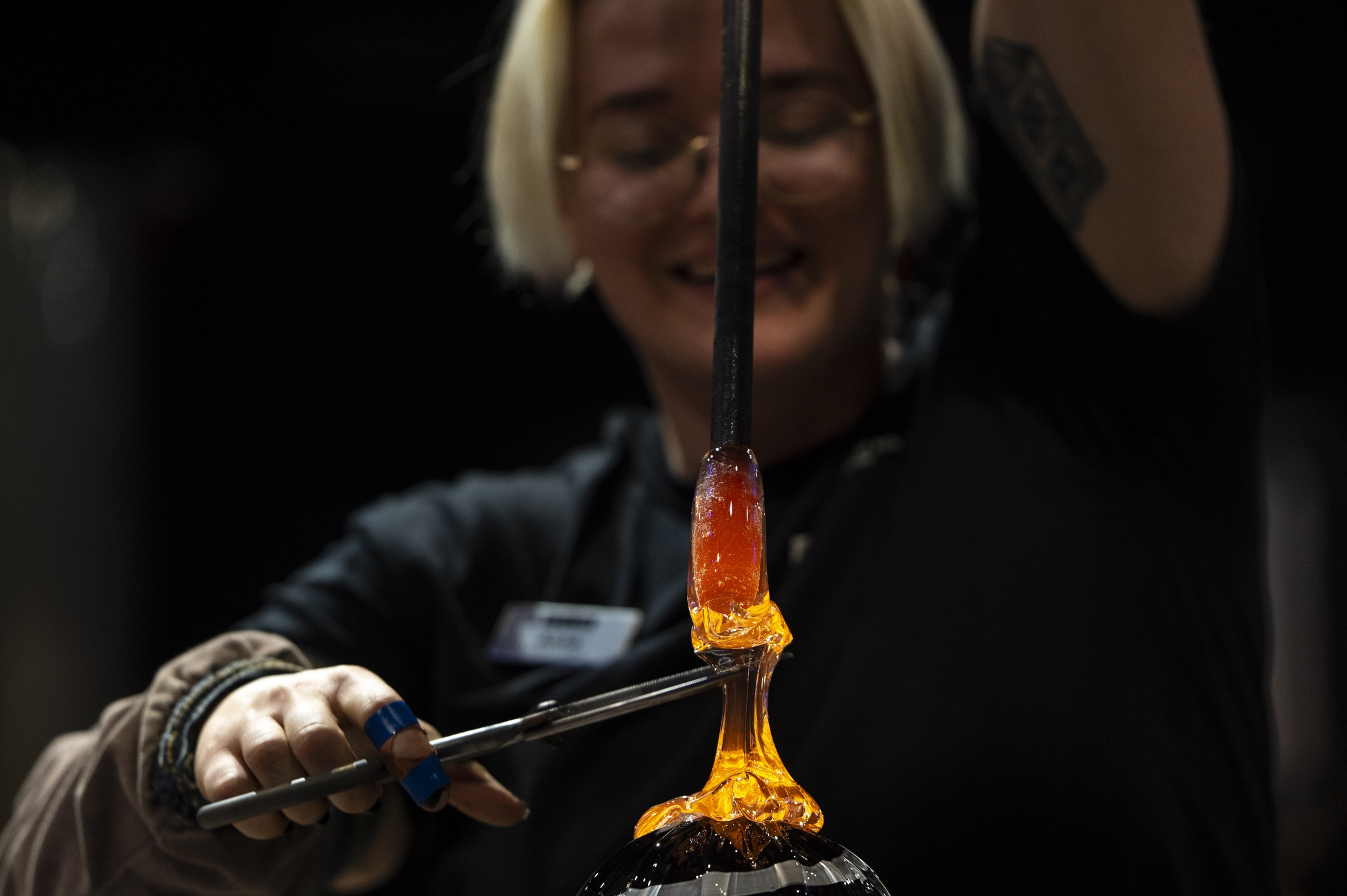 A glassblower named Anna forms a handle onto a large glass ornament during the 40th annual Holiday Walk at the Flint Institute of the Arts on Tuesday, Dec 2, 2025.