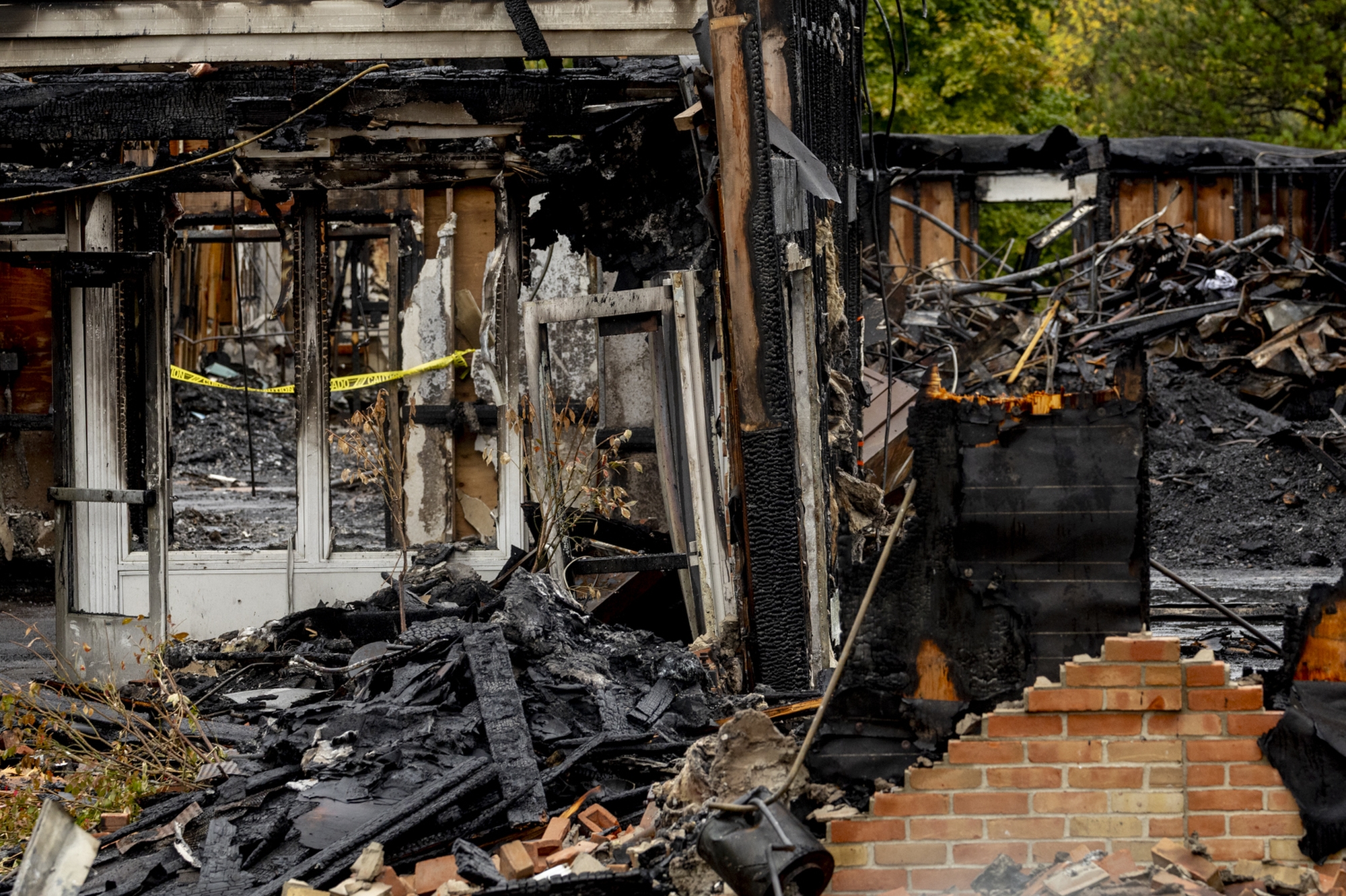Charred walls still stand amidst the rubble at the site of The Church of Jesus Christ of Latter-day Saints, located at 4285 McCandlish Road, on Tuesday, Oct. 7, 2025, on the first day that McCandlish Road reopened in Grand Blanc Township after a fire and shooting that killed four people with several others injured occurred.
