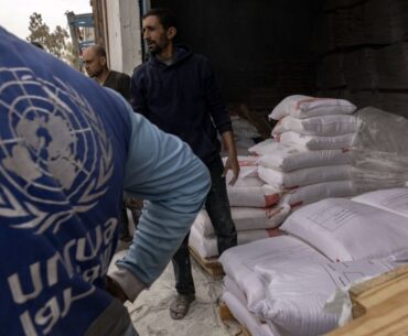 Sacks of flour are distributed in Gaza City from a center run by the United Nations Relief and Works Agency — widely known as UNRWA — on April 1, 2025. Israel’s Parliament passed new legislation on Monday, Dec. 29, 2025, formally removing diplomatic immunity from the agency. (Saher Alghorra/The New York Times)