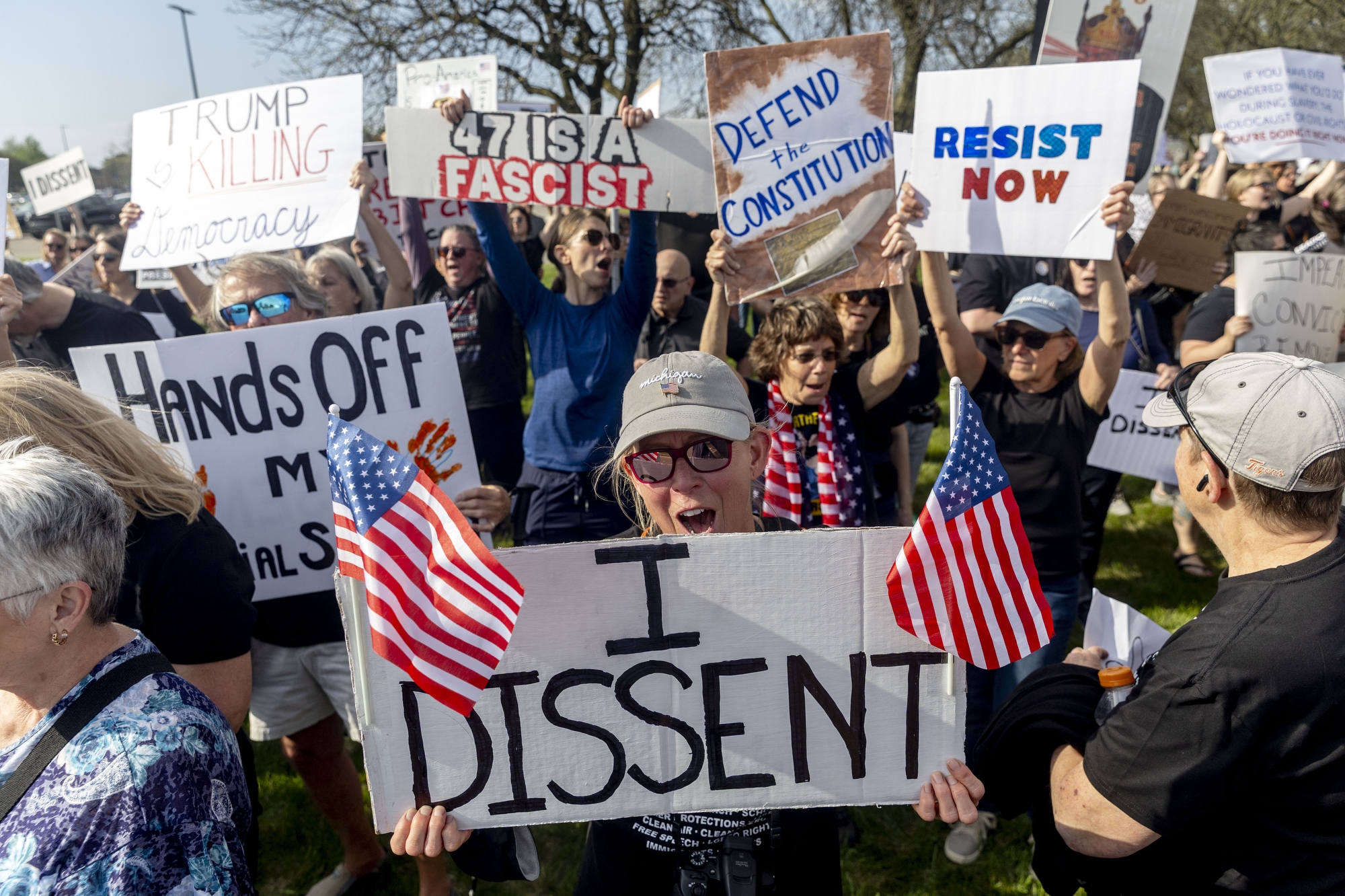 More than 3,000 people protest President Donald J. Trump as he delivers a speech about the successes of his first 100 days in office on Tuesday, April 29, 2025 at Macomb Community College in Warren.