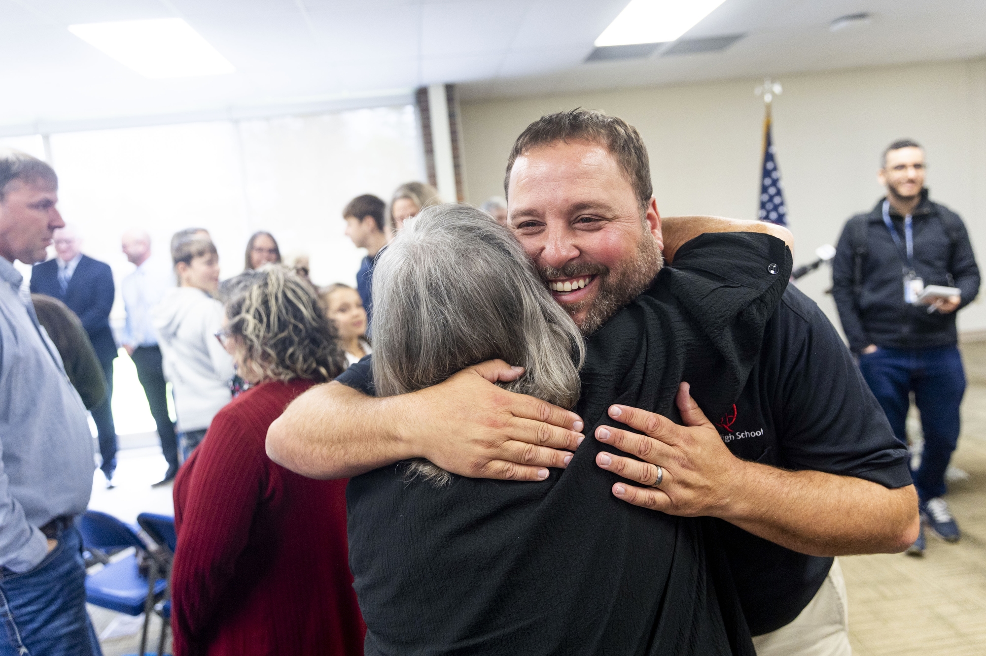 Family and friends rush to embrace Corey Rosser, a longtime educator at Quest High School in North Branch, after he was named Michigan Teacher of the Year on Tuesday, May 6, 2025 during Teacher Appreciation Week. Jake May | MLive.com