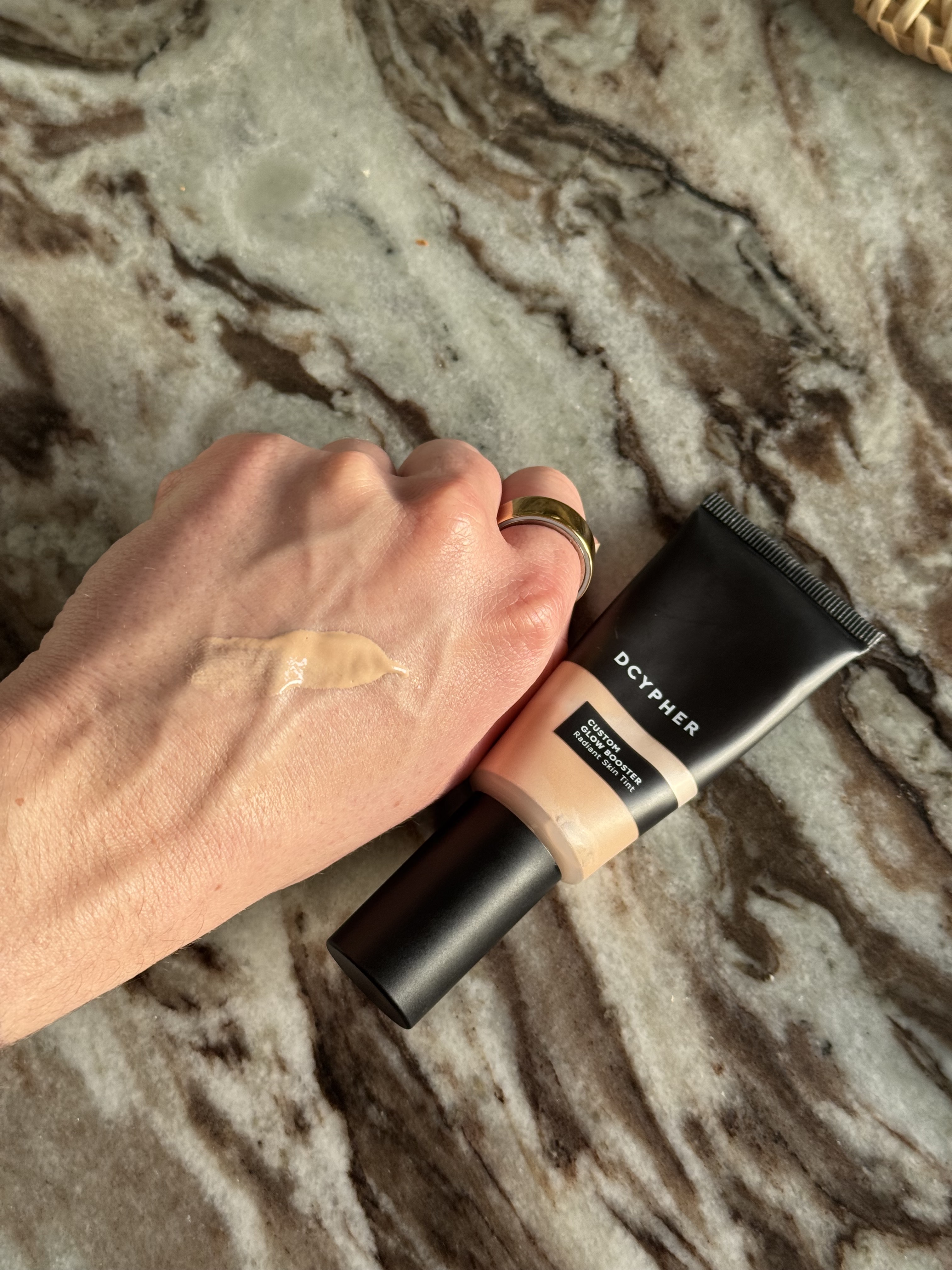 Eleanor swatching her Dcypher custom glow booster on her hand