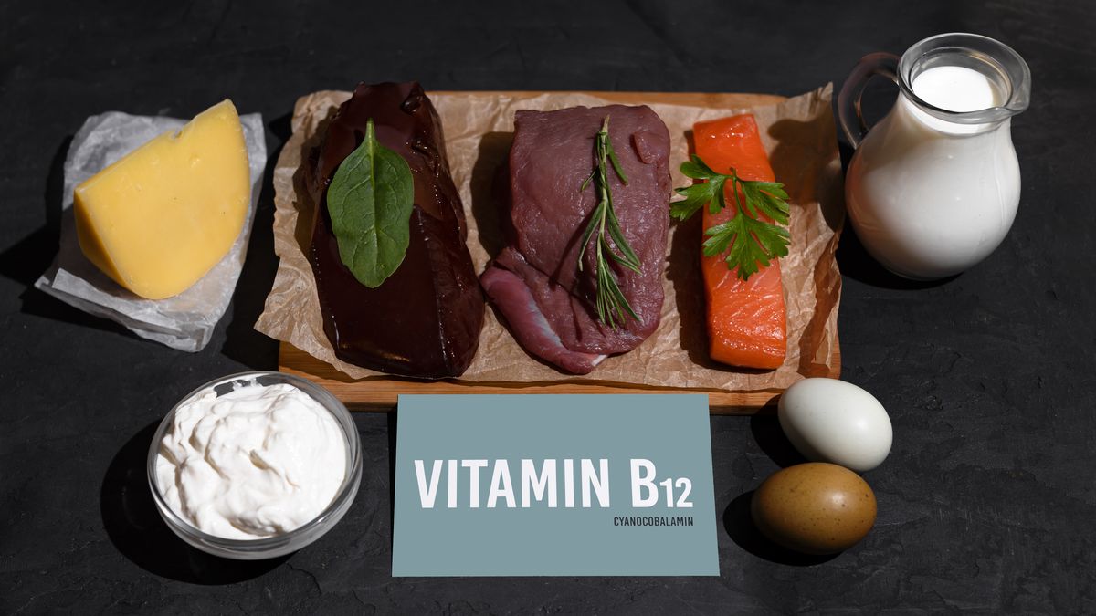 A set of natural products rich in vitamin B12 cobalamin. Healthy food concept. Cardboard sign with the inscription. Black background.