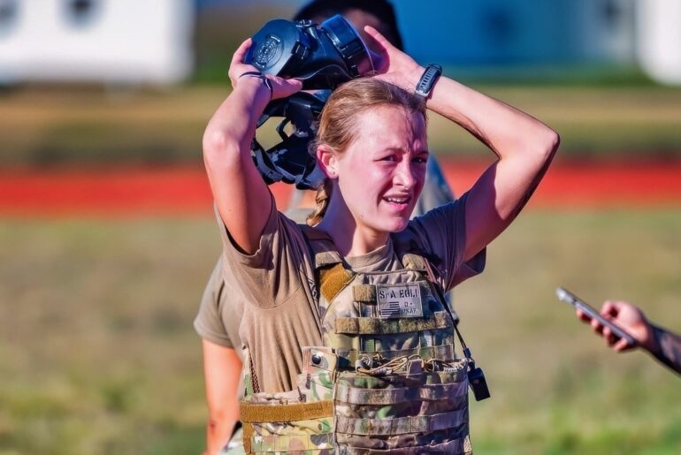 Senior Airman Paige Egli, 90th Security Forces Squadron installation entry controller, takes off her gas mask after running 400 meters during the Crow Creek Challenge at F.E. Warren Air Force Base, Wyoming, Oct. 3, 2025. The Crow Creek Challenge is an annual endurance event where participants ruck across the installation, tackling physical and mental stations designed to boost resilience, teamwork, and operational readiness. (U.S. Air Force photo by Airman Nicholas Rowe)