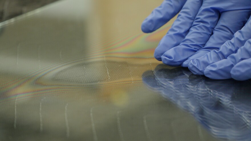 The artist Justin Ginsberg applies pressure to a plane of glass.