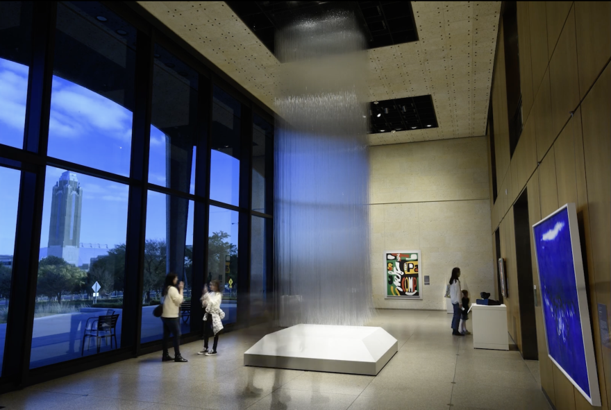 A 30 foot sculpture composed of strands of glass hang in the Amon Carter Museum of American Art
