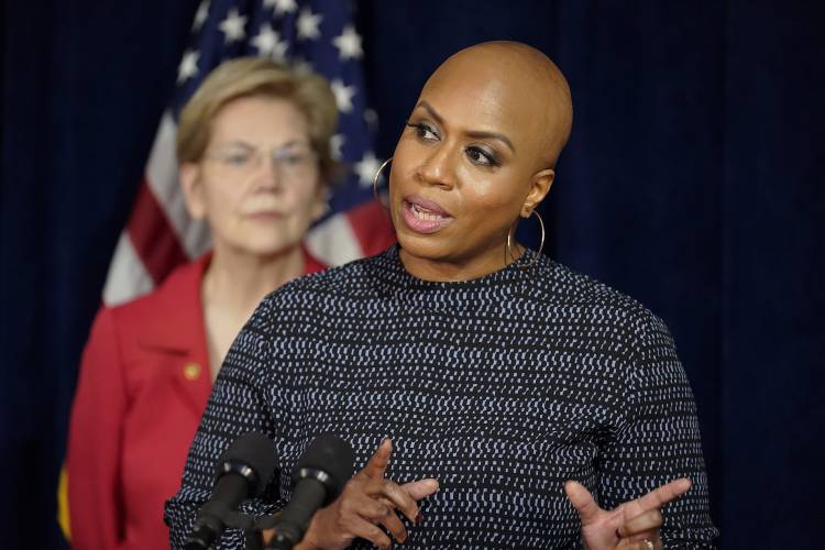 U.S. Rep. Ayanna Pressley, D-Mass., right, responds to questions from reporters as U.S. Sen. Elizabeth Warren, D-Mass., left, looks on during a news conference, Thursday, April 1, 2021, in Boston. The news conference was held to call on President Biden to use the Higher Education Act to cancel a share of student loan debt for students with federal loans. (AP Photo/Steven Senne)