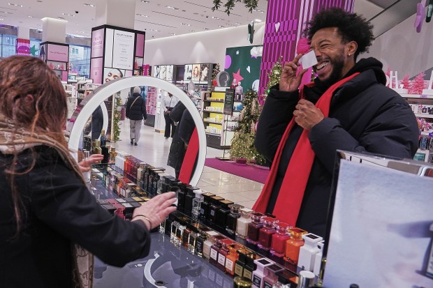 Ivan Leon chooses from Tom Ford fragrances at a Nordstrom department store. (AP Photo/Richard Drew)