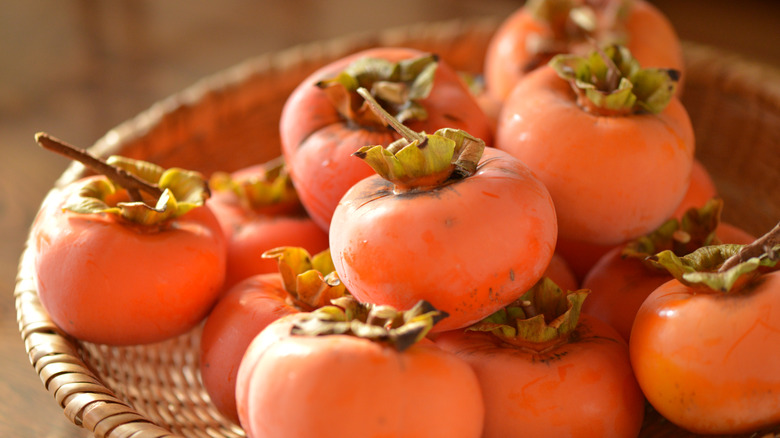 fuyu persimmons in a wicker basket