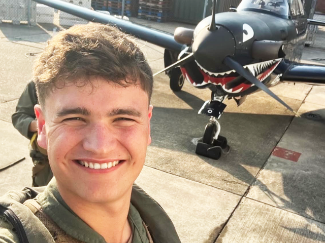 Montague stands in front of a plane