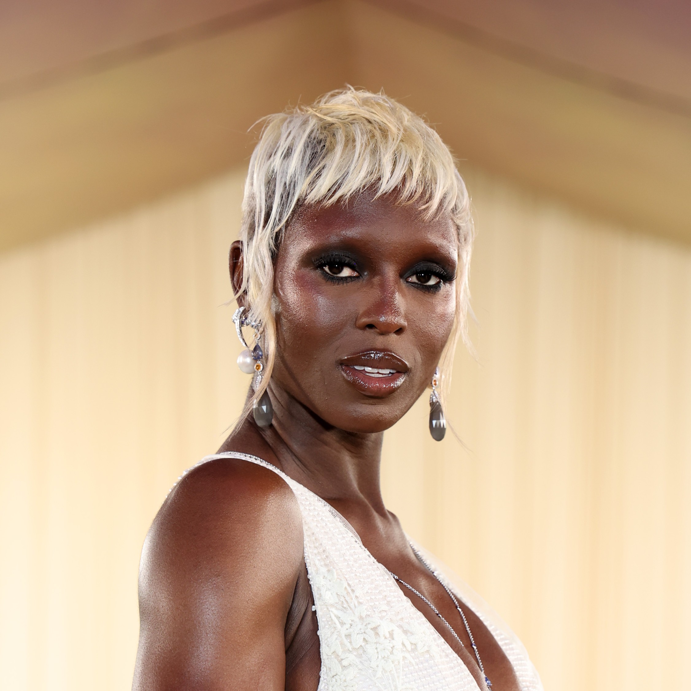 Jodie Turner-Smith with her hair dyed, micro bangs, and no eyebrows.