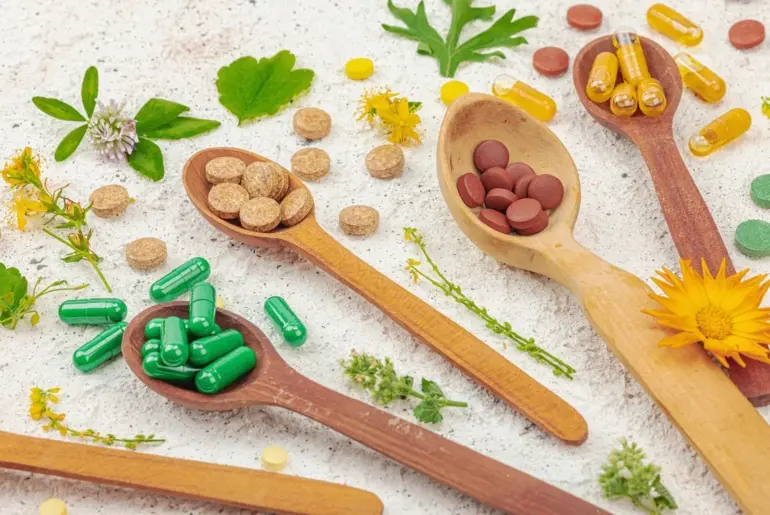 supplements, natural vitamins with fresh herbs and flowers.