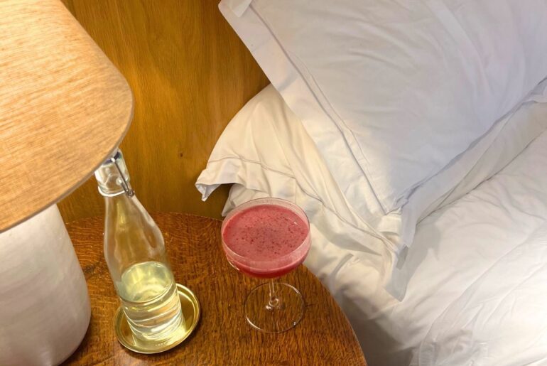 newroad 30 supplement on a bedside table next to white bedding