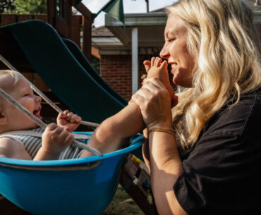 Jasmin Day cradles her baby in a swing, capturing a tender moment for FACES.
