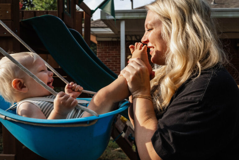 Jasmin Day cradles her baby in a swing, capturing a tender moment for FACES.