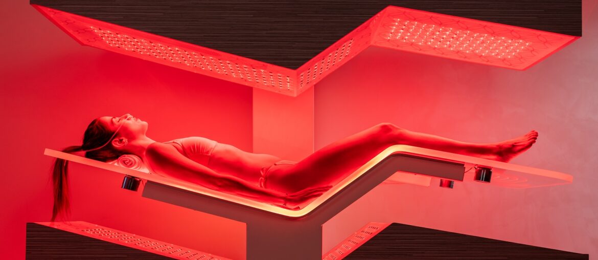 wellness trends - woman lying on Ammortal infra red bed