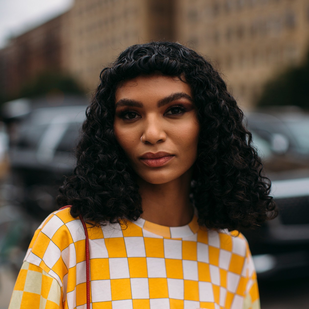 A model wearing their hair styled with micro bangs.