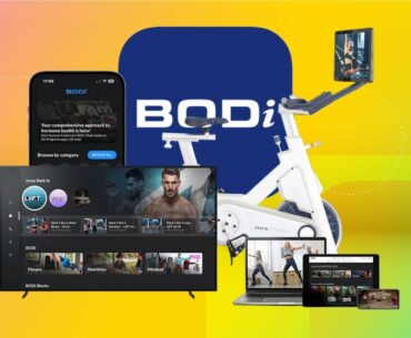 A TV, phone, laptop and and tablet with an exercise bike and the Bodi app logo against a yellow gradient CNET background.