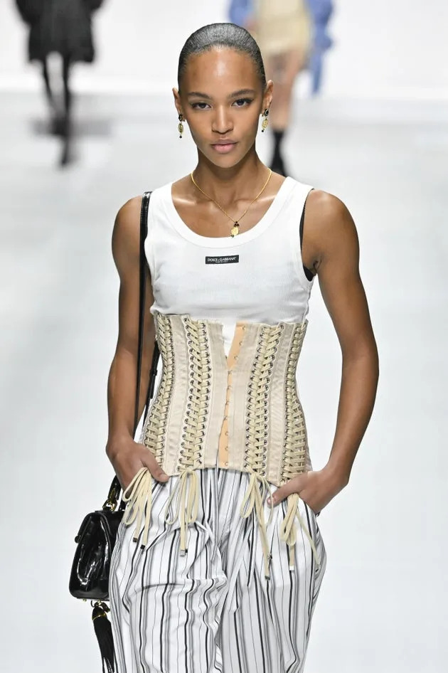 A model walks the runway in a corset during the Dolce & Gabbana ready to wear spring/summer 2026 fashion during Milan Fashion Week on Sept. 27.