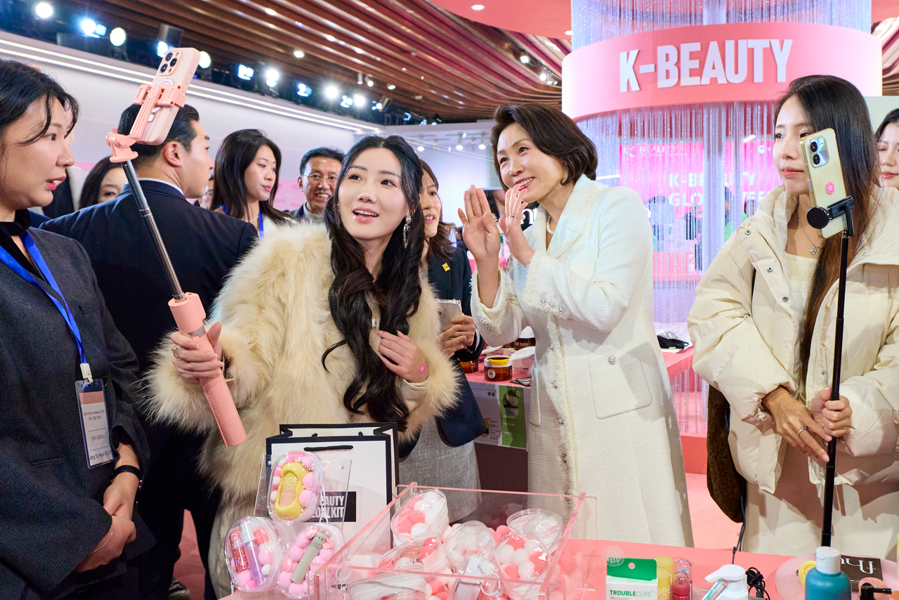 First lady Kim Hea Kyung takes a selfie with a participant at K-Beauty GLOW WEEK, a promotional event for Korean beauty products, at the Shanghai Propaganda Poster Art Center in Shanghai on Wednesday. Kim is accompanying President Lee Jae Myung on his state visit to China. (Yonhap)