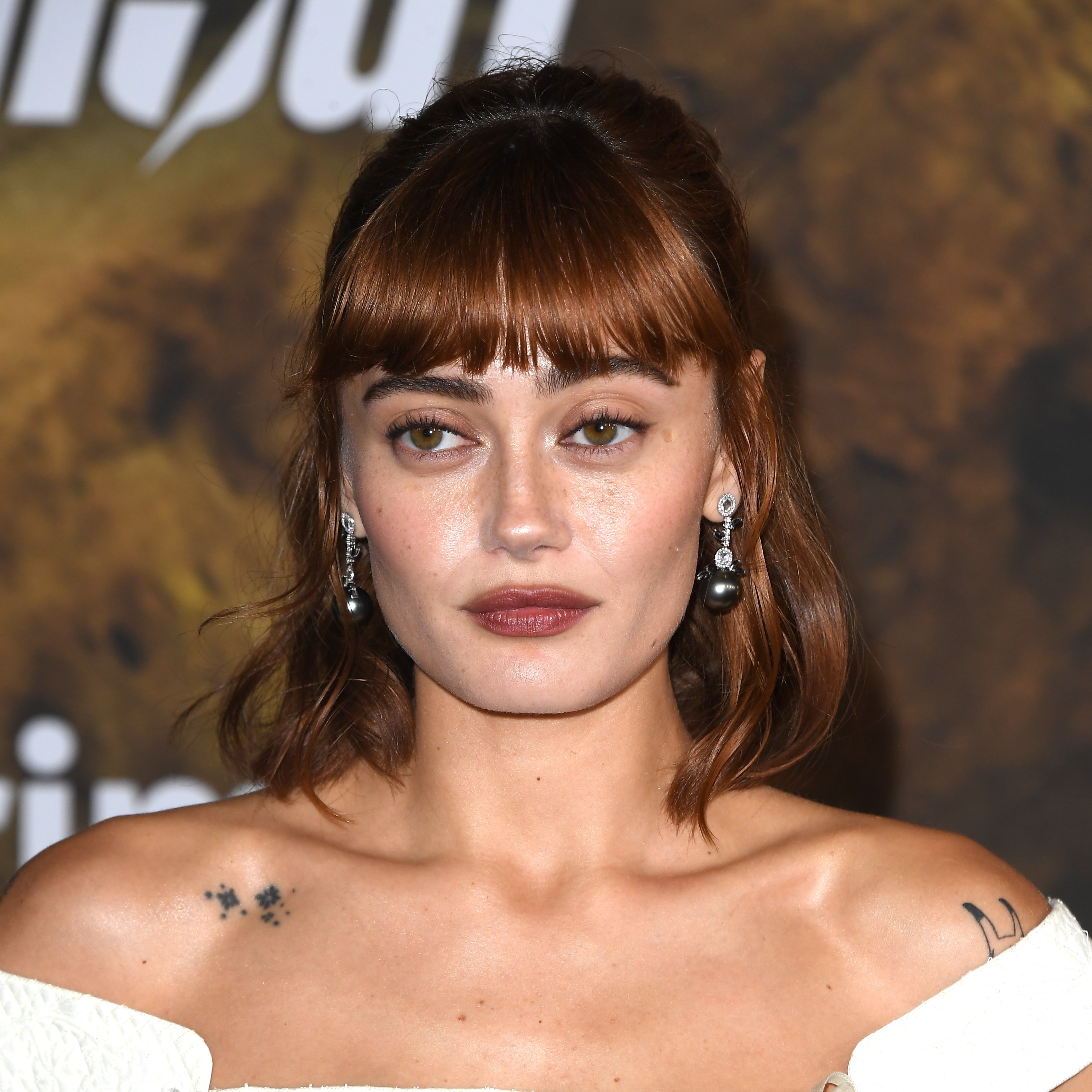 Ella Purnell with a half-up micro bang hairstyle.