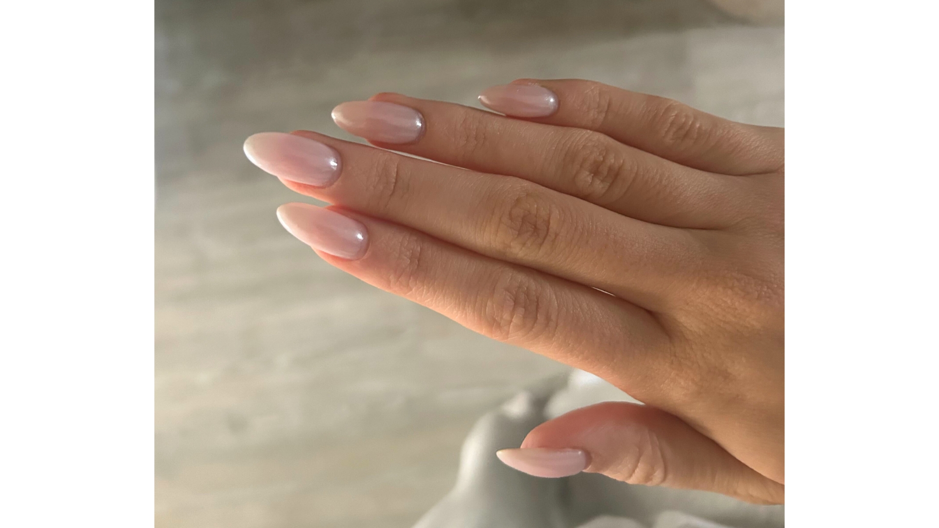A close-up picture of Digital Beauty Writer, Sennen Prickett's long almond, pink chrome nails