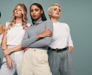 A group of fashion models posing together.