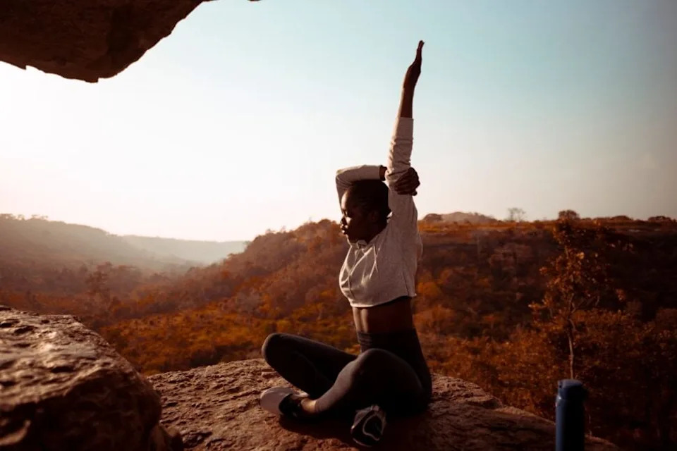 woman practicing yoga outdoors in Ghana