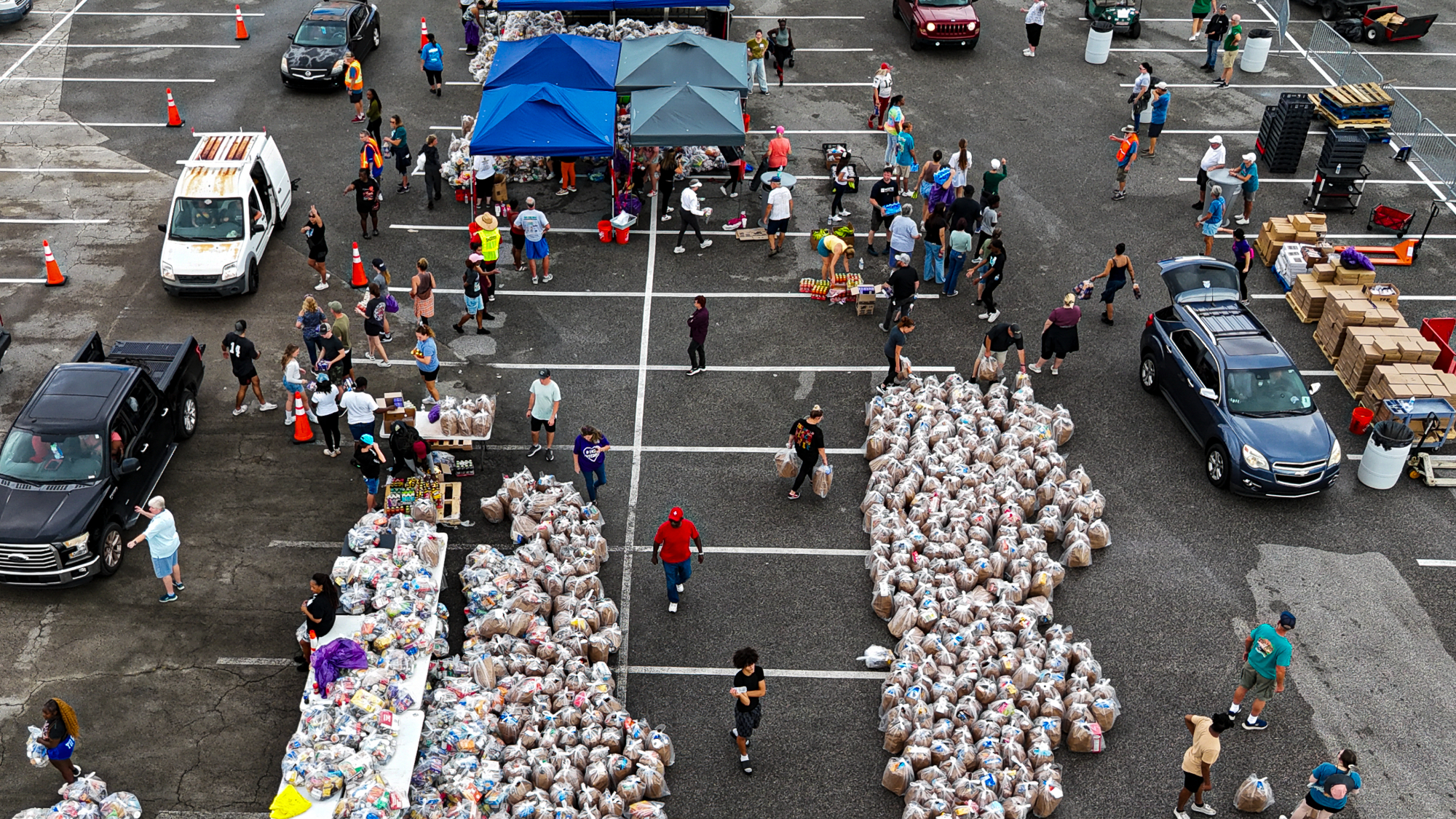 Daytona Beach residents line up in their cars during a free food distribution for recipients of SNAP on November 9, 2025. The US Supreme Court said on November 7 that the Trump administration does not have to immediately pay SNAP food benefits defunded during the government shutdown. 