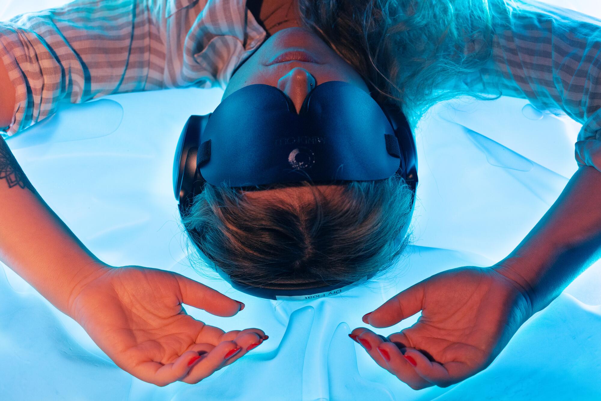 A woman wearing a blindfold in a dry float tank at Quantum Wellness on Monday, Feb. 2, 2026, in Los Angeles