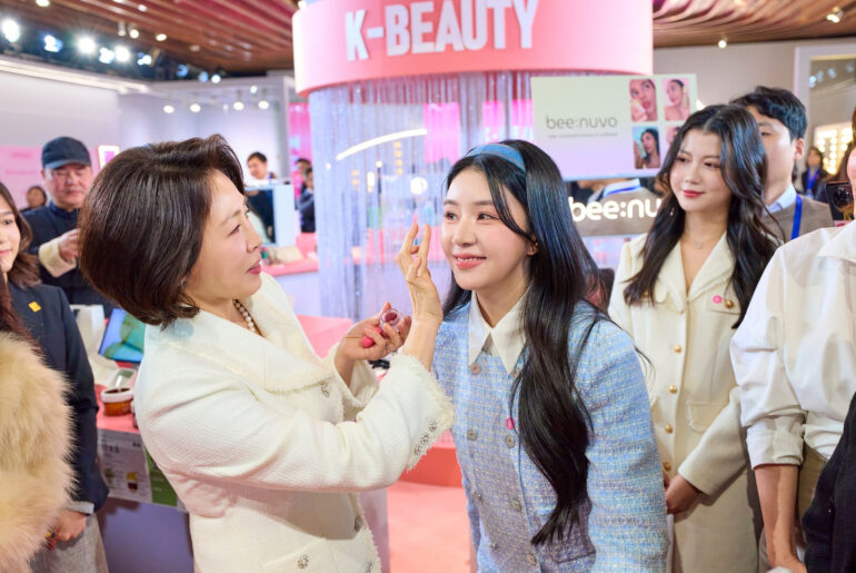First Lady Kim Hea Kyung, left, applies cosmetics to an attendee